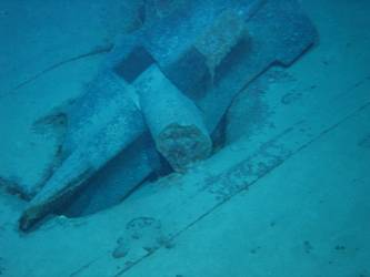 Stbd anchor embedded in steel plate from ship's side in debris field